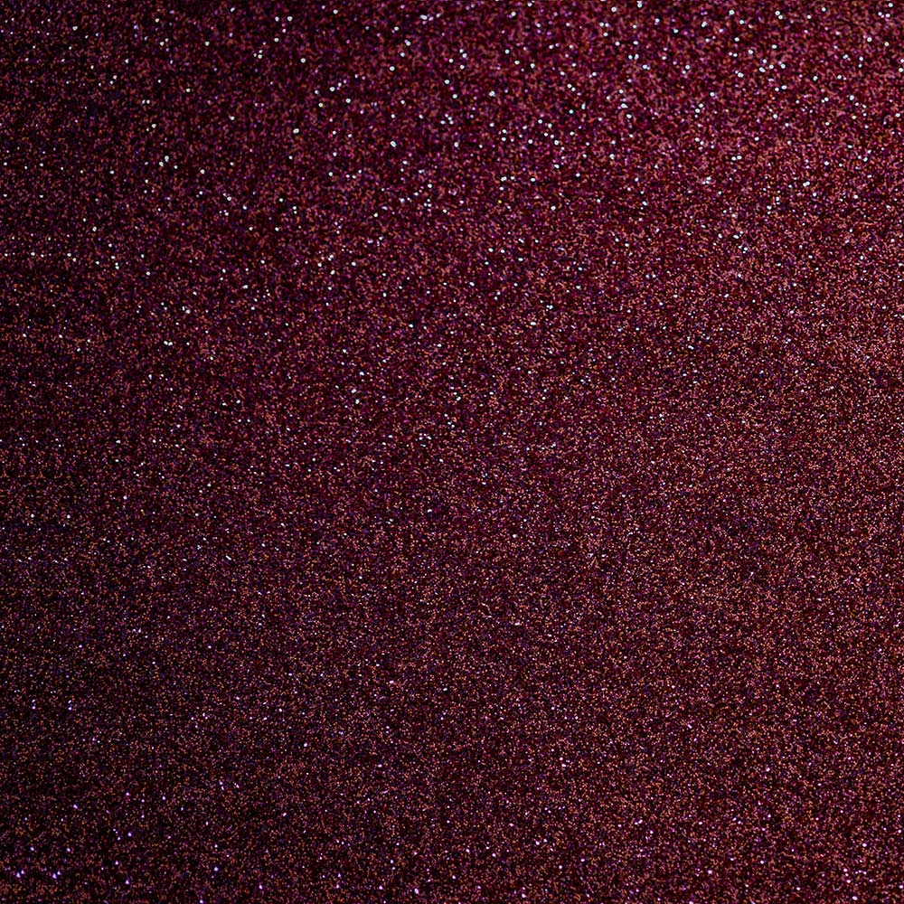 Close-up of Vitamin B12 (Cyanocobalamin), showing its deep burgundy colour and fine, shimmering texture.